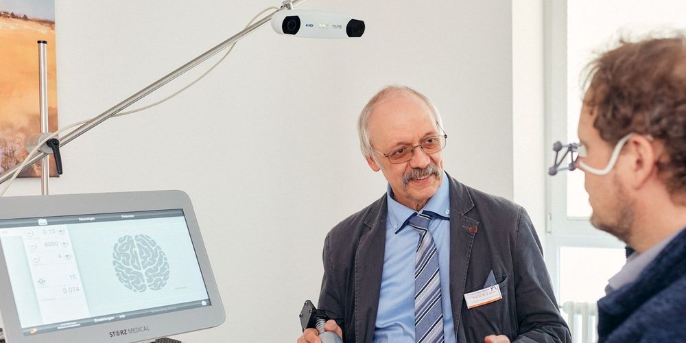 Departmentleiter Neurostimulatoinszentrums in Neuss wendet die Transkranielle Pulsstimulation (TPS) bei einem Patienten an